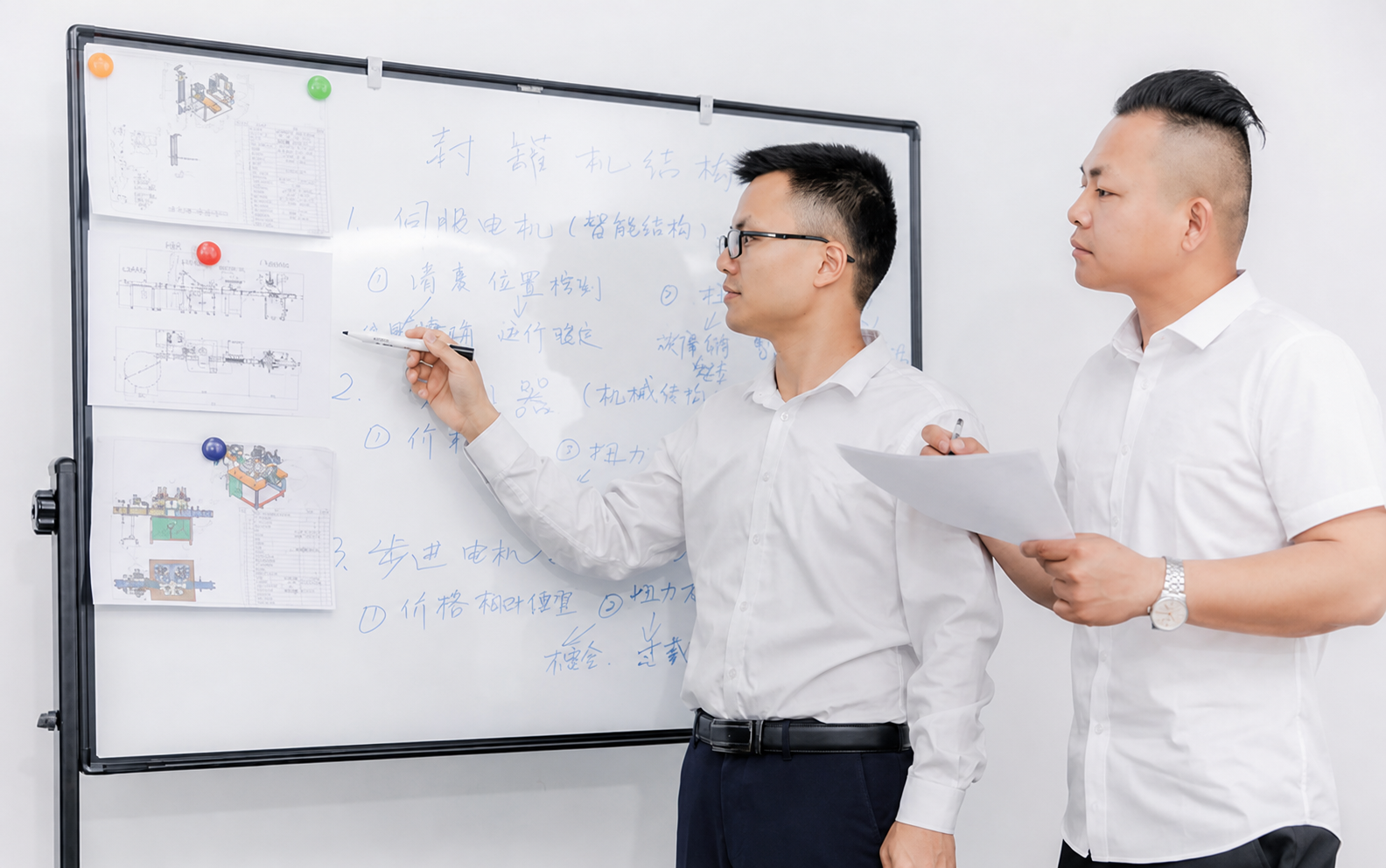 Engineers discussing a custom can packaging machine design