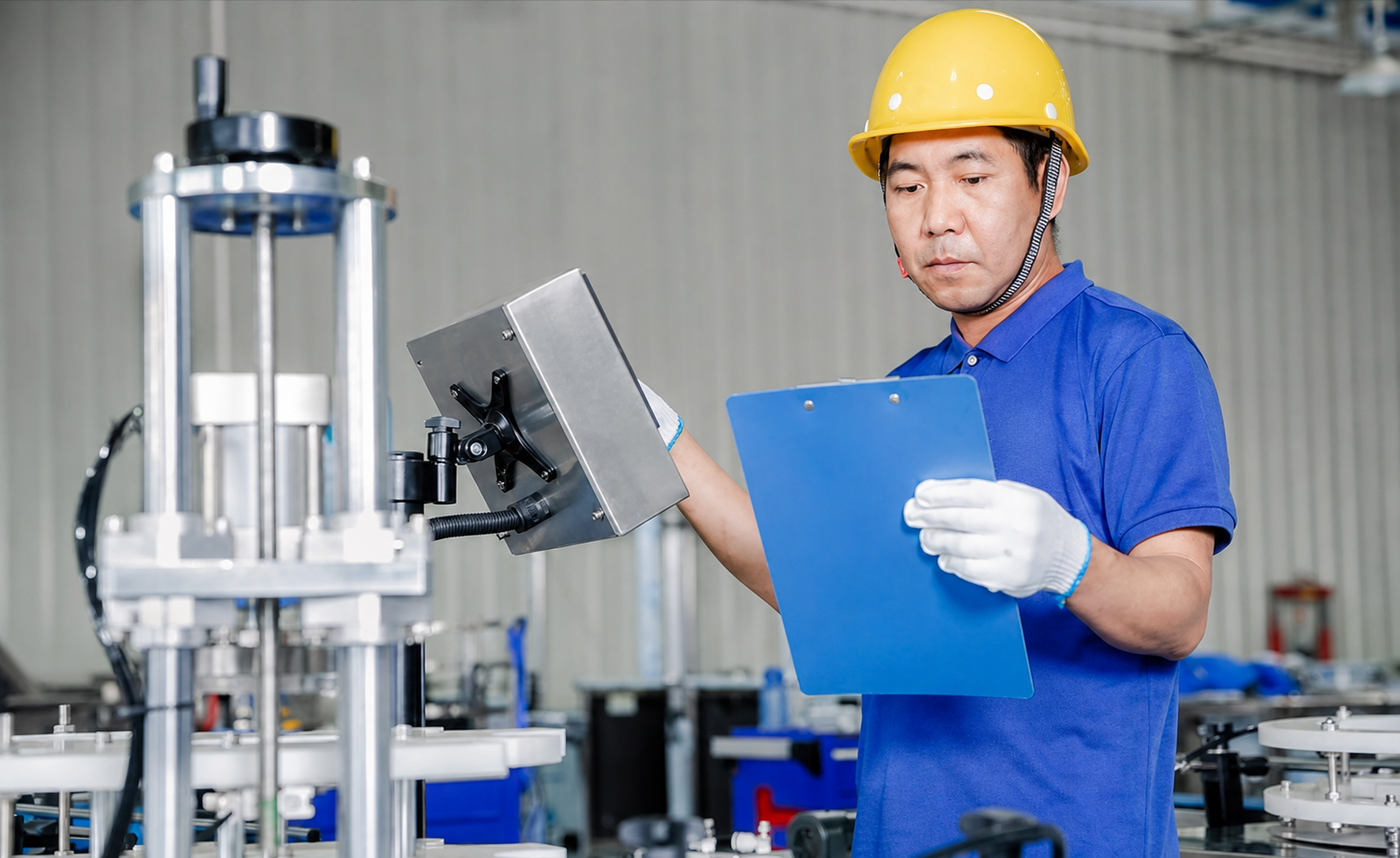 Technician inspecting a can packaging machine